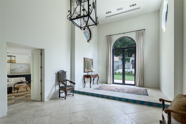 doorway to outside with a high ceiling