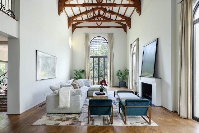 living room featuring high vaulted ceiling, a wealth of natural light, and beamed ceiling