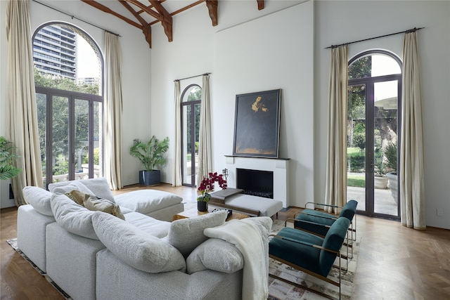 living room with a towering ceiling, parquet floors, and ceiling fan