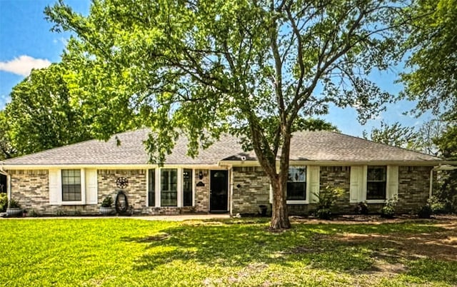 ranch-style home featuring a front yard