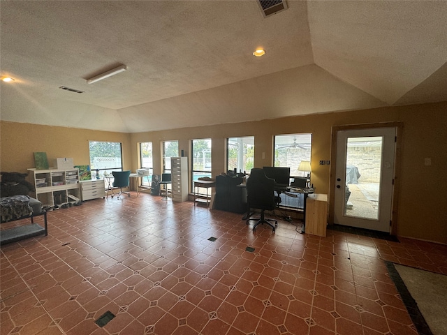 interior space featuring vaulted ceiling and a textured ceiling