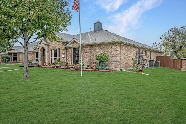 view of front of house featuring a front yard and cooling unit