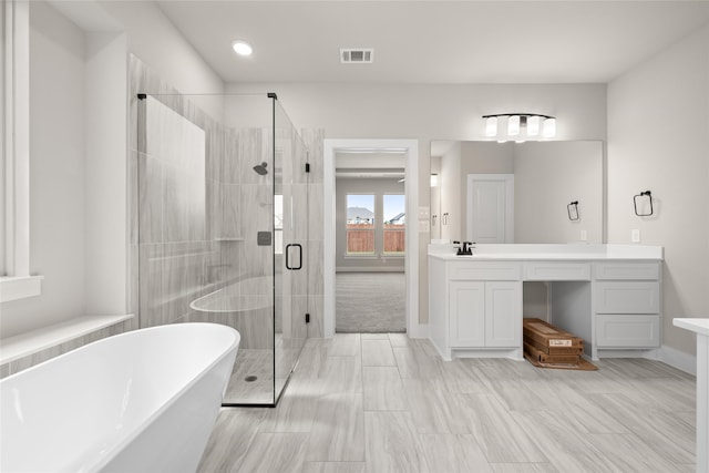 bathroom featuring vanity and separate shower and tub