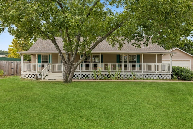 ranch-style house with a shingled roof, a front yard, covered porch, and fence