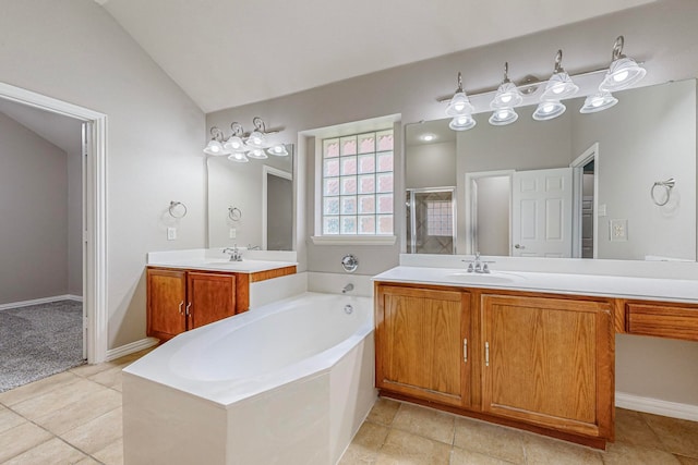 bathroom featuring vanity, vaulted ceiling, tile patterned floors, and separate shower and tub