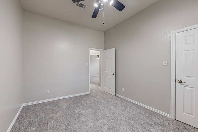 carpeted empty room featuring ceiling fan and vaulted ceiling