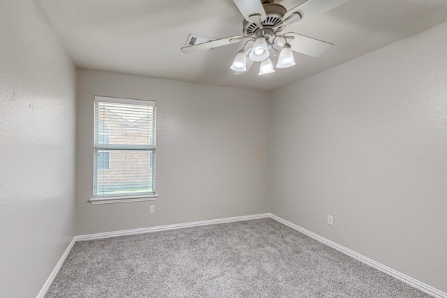 carpeted spare room with ceiling fan