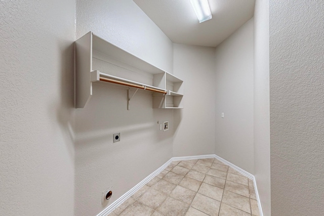 washroom featuring washer hookup, hookup for an electric dryer, and light tile patterned flooring