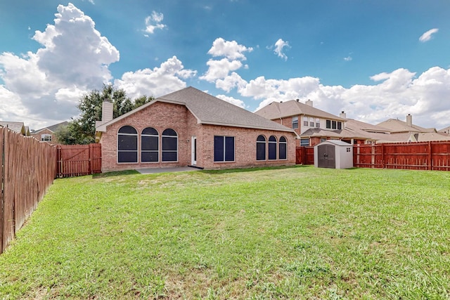 back of property with a lawn and a shed