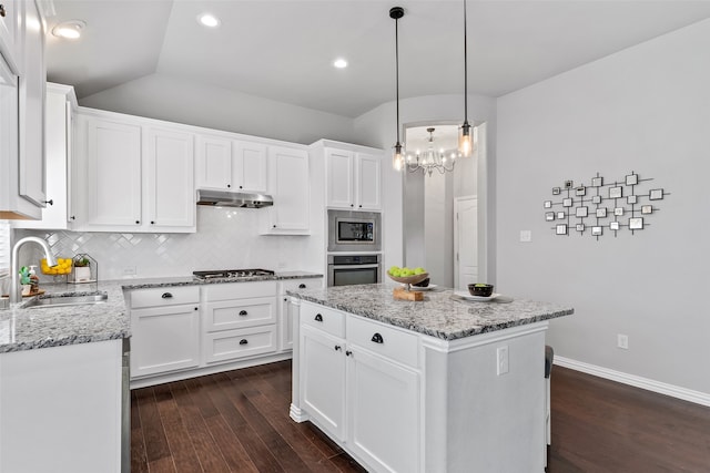 kitchen featuring sink, a kitchen island, dark hardwood / wood-style flooring, white cabinets, and appliances with stainless steel finishes