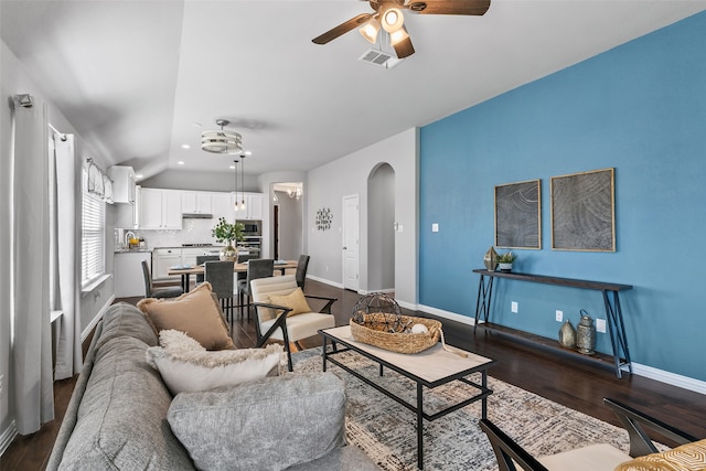 living room with ceiling fan and dark hardwood / wood-style flooring