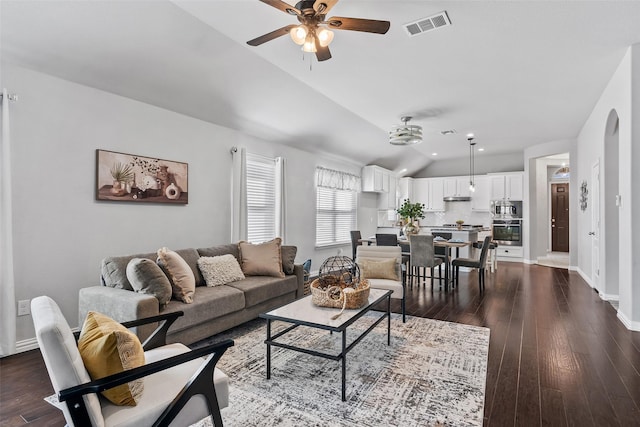 living room featuring ceiling fan, dark hardwood / wood-style flooring, and lofted ceiling