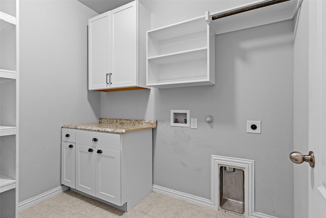 washroom with cabinets, hookup for a washing machine, gas dryer hookup, electric dryer hookup, and light tile patterned floors