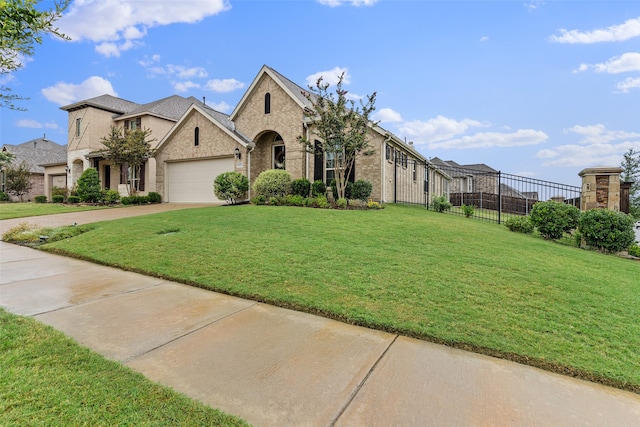 view of front of property with a front lawn and a garage