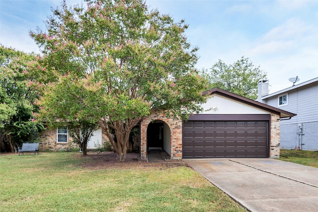 view of front of property with a front yard, concrete driveway, brick siding, and an attached garage