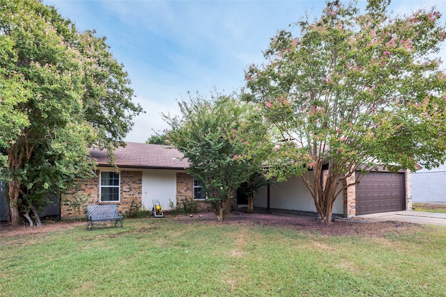 view of front of house with a garage and a front lawn