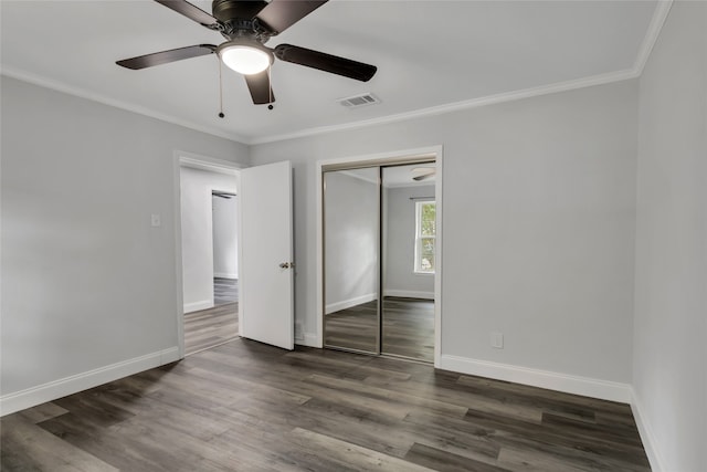 unfurnished bedroom with ceiling fan and dark hardwood / wood-style floors