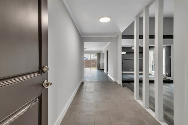 corridor with wood-type flooring and crown molding