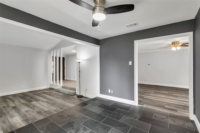 spare room with dark hardwood / wood-style flooring and ceiling fan