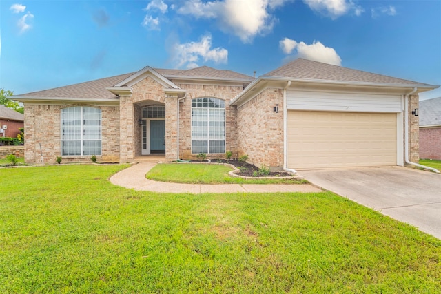 ranch-style home featuring a garage and a front lawn