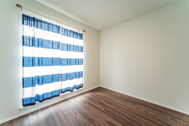 unfurnished room with wood-type flooring