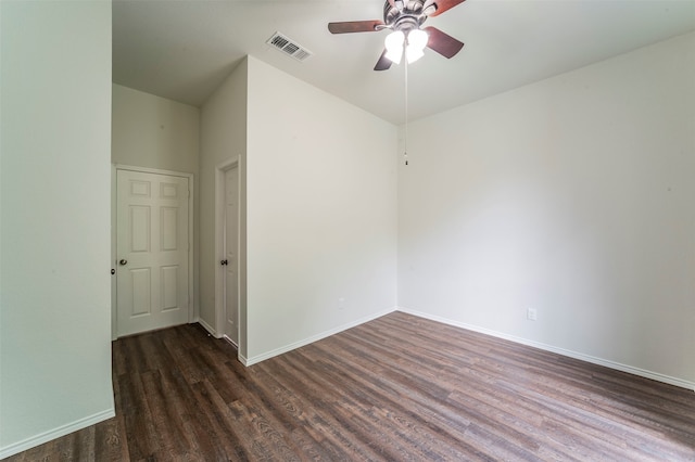 empty room featuring dark wood-type flooring and ceiling fan