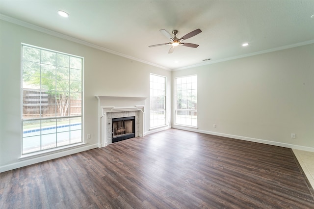 unfurnished living room featuring crown molding, ceiling fan, hardwood / wood-style flooring, and a fireplace