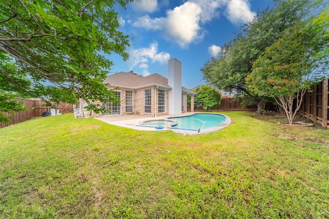 view of swimming pool featuring a lawn and a patio