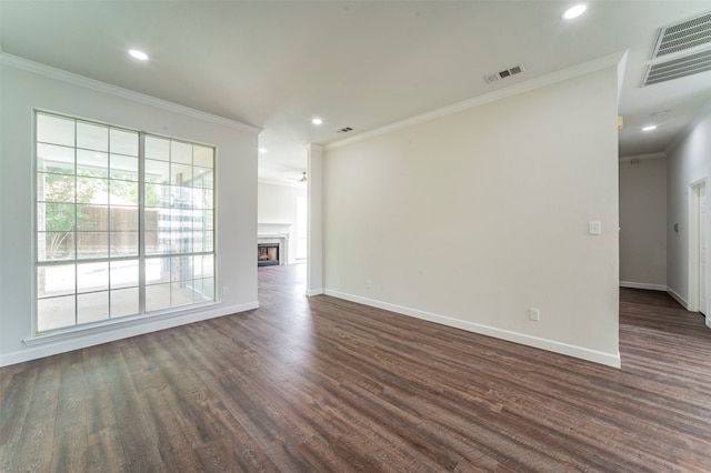 unfurnished living room with crown molding and dark wood-type flooring