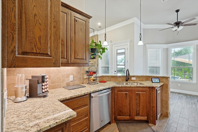 kitchen with plenty of natural light, sink, kitchen peninsula, and stainless steel dishwasher