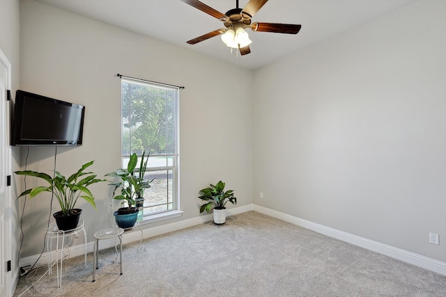 unfurnished room featuring light carpet and ceiling fan