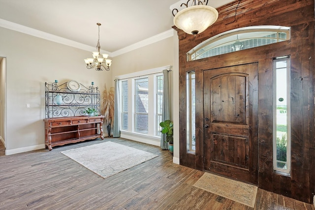 entryway with ornamental molding, hardwood / wood-style flooring, and a healthy amount of sunlight