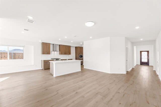 empty room with light hardwood / wood-style flooring