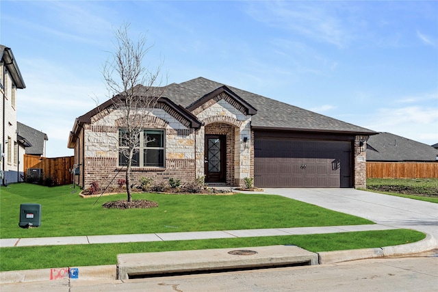 view of front of property featuring a garage and a front yard