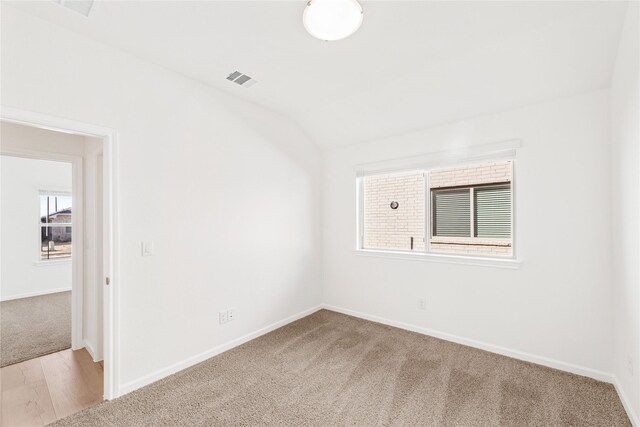 full bathroom with toilet, vanity, tiled shower / bath, and vaulted ceiling