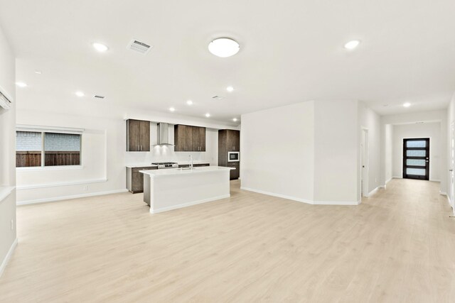 living room with hardwood / wood-style floors, ceiling fan, and sink