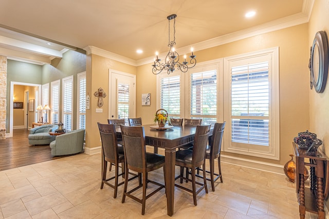 dining space featuring crown molding and an inviting chandelier