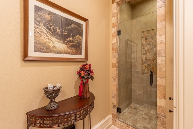 bathroom featuring a shower with shower door