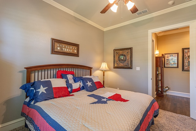 bedroom with crown molding, dark hardwood / wood-style flooring, and ceiling fan