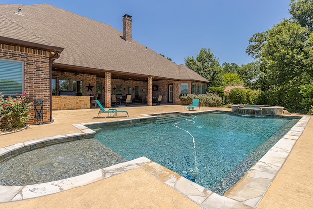 view of swimming pool featuring a patio area and an in ground hot tub