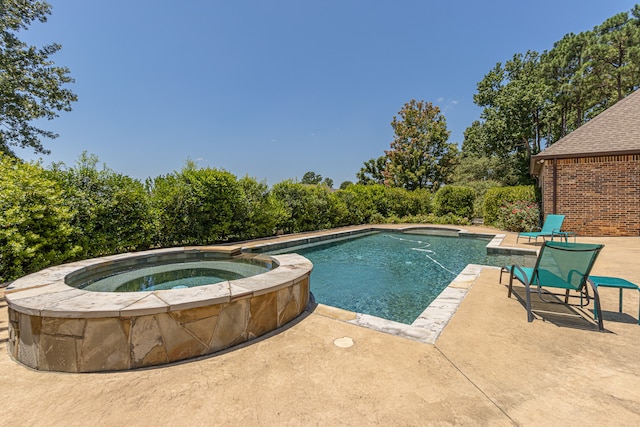 view of swimming pool with a patio area and an in ground hot tub