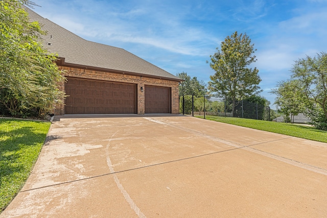 exterior space featuring a garage and a front yard