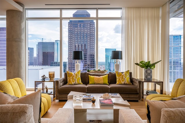 living room featuring a wall of windows and light hardwood / wood-style floors