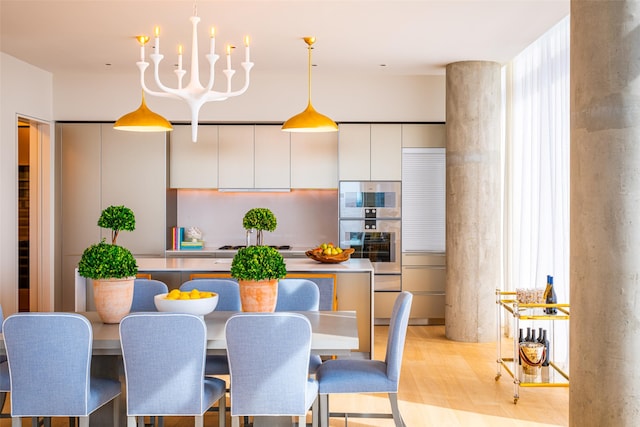 dining area featuring an inviting chandelier and light hardwood / wood-style floors