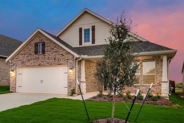 craftsman house featuring a garage and a lawn