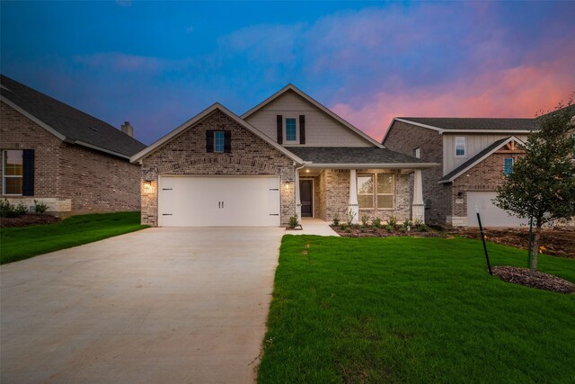 craftsman inspired home with a yard and a garage