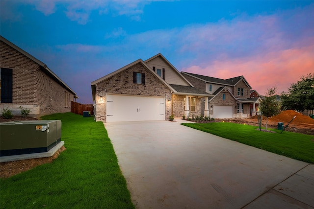 craftsman-style home with a lawn, a garage, and central AC