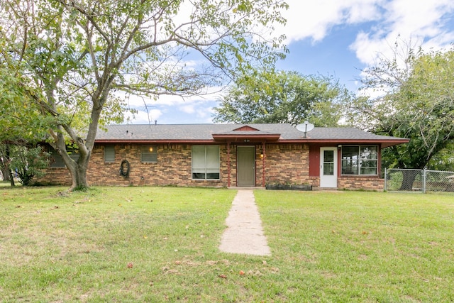 ranch-style house with fence, brick siding, and a front yard