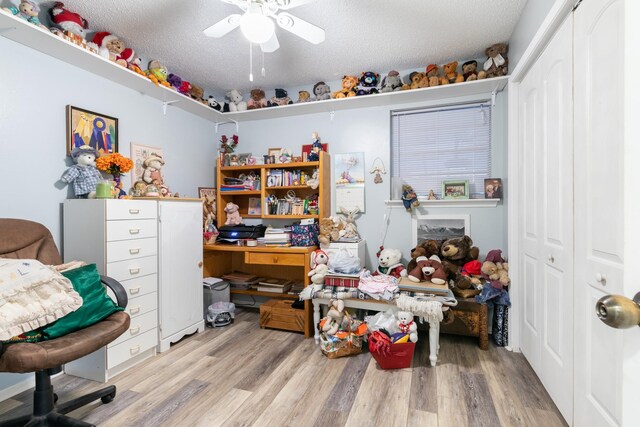 interior space featuring wood finished floors, a closet, and a ceiling fan