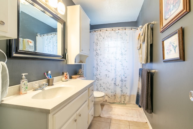 bathroom featuring toilet, tile patterned flooring, vanity, a textured ceiling, and a shower with shower curtain